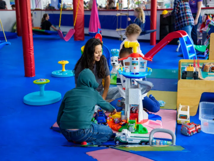 Care Specialist Michelle playing with children during a community outing